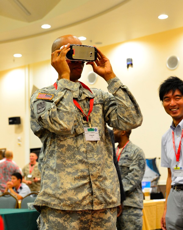 Capt. Julian Kirk, USA, enjoys a demonstration of virtual reality goggles by NTT Docomo at the TechNet Day in October.