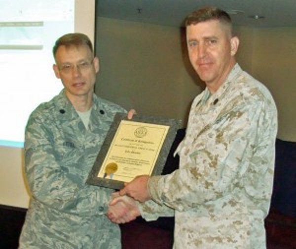 In April, Timothy D. French (r), Marine Corps Base Japan G-6, receives a lifelong membership certificate from Lt. Col. Adam Little, USAF, chapter president.