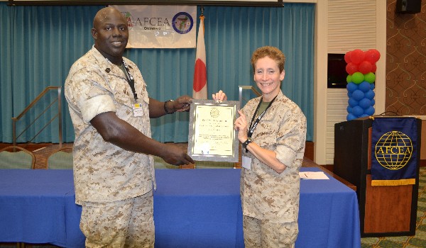 In October, Master Gunnery Sgt. Arthur Allen III, USMC, chapter president and communications chief, III Marine Expeditionary Force, presents a Life Member certificate and pin to Col. Vandenberg.