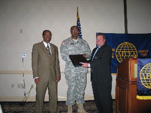 Jerry Sirmans (l), vice president of the local  International, Test & Evaluation Association chapter, Col. David Lockhart, USA, project manager with Project Manager Instrumentation, Targets and Threat Simulators and  Jerry Stahl (r), president of Orlando-Central Flordia Chapter, gather for the presentation  to Col. Lockhart at the chapter's November meeting. 

