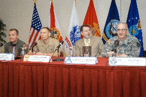At the January Defense Forum, speakers include (L-R) Col. Lou Olinto, USAF; Col. Frank Kelley, USMC; Bob Mathews; and Col. Kevin Dietrick, USA.

