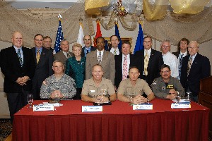 The AFCEA chapter co-hosted the 9th Annual Team Orlando Defense Breakfast Forum with members from the Central Florida Combined Professional Associations Group (CPAG) in January. Speakers and chapter presidents include (front row, l-r) Col. Kevin Wheeler, USA, Program Executive Office for Simulation, Training and Instrumentation; Capt. Bill Reuter, USN, commander, Naval Air Warfare Center Training Systems Division; Col. Frank Kelley, USMC, program manager, Training Systems; and Col. James Dennis, USAF, commander, Air Force Agency for Modeling and Simulation. Back row (l-r) is Paul Hanover, De Voorhees, Ken Meyer, Russ Hauck, Mary Trier, Fred Eisele, Jerry Sirmans, Roger Smith, Jerry Stahl, Andy Mohler, Ed Smith, Keith Gardner and Jim Callahan.