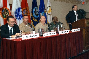 Addressing attendees at the chapter's January meeting are (l-r) Steve Painter, chapter president; Rob Reyanga, Program Executive Office for Simulation, Training and Instrumentation; Col. David Smith, USMC, program manager for training systems; Capt. William Reuter, USN, Naval Air Warfare Center Training Systems Division; and Col. Marcus Boyd, USAF, Air Force Agency for Modeling and Simulation.