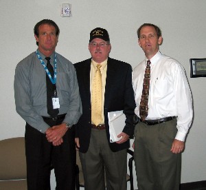 Dr. Roger Smith (r), chapter president, and Jeff Jancek (l), chapter president for the Central Florida Chapter of the Navy League of the United States, present a token of appreciation to Robert M. Mathews, director of acquisition and operations, Naval Air Warfare Center Training Systems Division, for his presentation at the July luncheon.