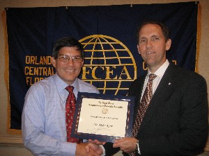 Roger Smith (r), chapter president, presents a chapter education award to Mike Agor, chapter vice president of education, at the May luncheon meeting.