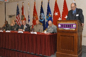 Fred Eisele (r), technical chairman of the conference, introduces the January conference's second panel: (l-r) Col. (S) Marcus Boyd, USAF, commander, Air Force Agency for Modeling and Simulation; Capt. Harry Robinson, USN, commanding officer, Naval Air Warfare Training Systems Division, Naval Air Station, Orlando; Al Resnick, director of the Assessments, Architecture and Battle Command, Army Capabilities Integration Center, Training and Doctrine Command; and Brig. Gen. Michael Brogan, USMC, commander, Marine Corps Systems Command; and panel moderator Maj. Gen. Nick Justice, USA, commanding general, U.S. Army Research, Development and Engineering Command.