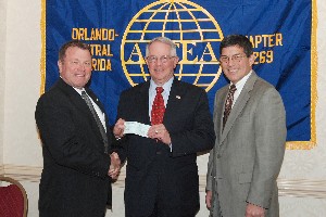 Jerry Stahl, chapter president (l), presents check to Lt. Gen. John Dubia, USA (c), for the AFCEA International Education Foundation in January while Mike Agor, chapter vice president for education, looks on.