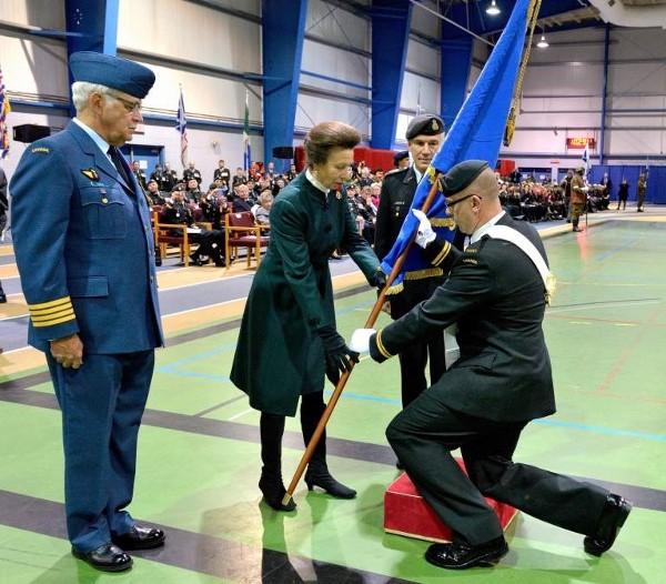 Her Royal Highness, The Princess Royal, Princess Anne, colonel-in-chief of the Communications and Electronics (C&E) Branch, presents the Royal Banner to the C&E Branch Subaltern of the Year, Lt. J. Kauenhofen, Canadian Forces, Joint Signals Regiment.