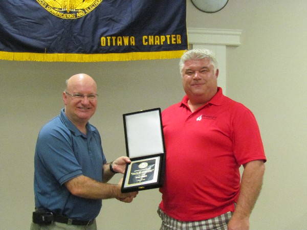 In May, Col. Martin Girard, DND (CFSSG), chapter president (l), presents Phirelight representative Doug Kirkpatrick with a Corporate Sponsorship award for the 2013-2014 year.