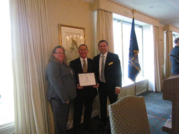 Chapter president Kelly Stewart-Belisle (l), vice president of executive breakfasts Pierre Gauthier (far r) and guest speaker David W. Weddel of Lockheed Martin attend the Executive Breakfast in September.