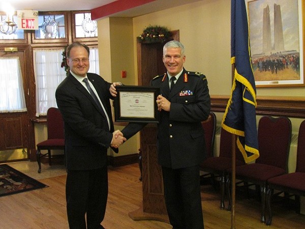 Dave Johnson, chapter vice president for programs, presents Maj. Gen. David Neasmith, National Defense, chief of staff, with a certificate of appreciation following his speech at the December luncheon.