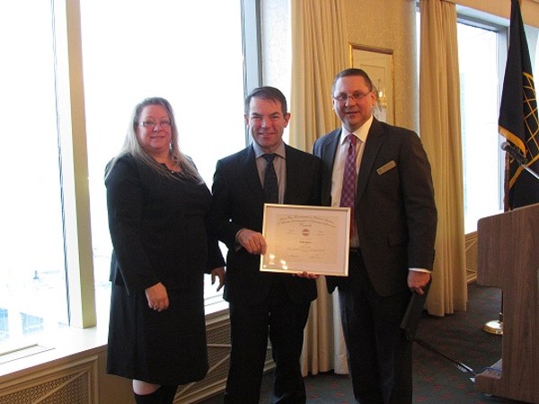 In December, Kelly Stewart-Belisle, chapter president, and Pierre Gauthier (r), chapter vice president of executive breakfasts, present a certificate to guest speaker Peter Bruce, senior assistant deputy minister, Projects and Client Relationships, Shared Services Canada.