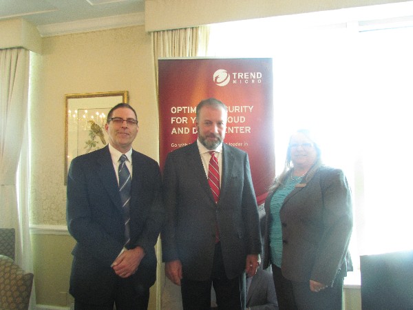 The June breakfast guest speaker John A. Glowacki Jr., chief operating officer, Shared Services Canada (c), is welcomed by Chapter President Kelly Stewart-Belisle and Angus MacDonald, a representative from Trend Micro, the event sponsor.