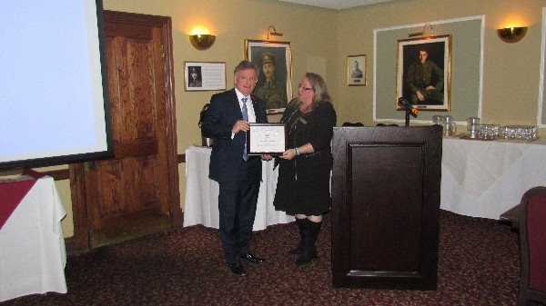 Guest speaker the Honorable David Pratt receives his certificate of appreciation and membership package from Chapter President Kelly Stewart-Belisle at the November luncheon. 