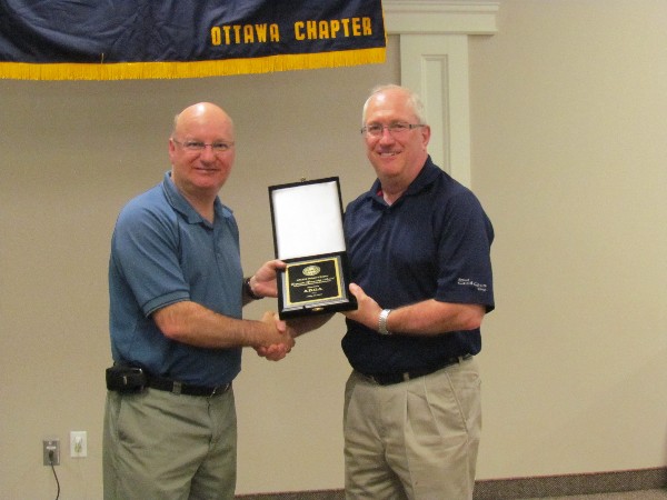 Col. Girard presents ADGA Group representative Brian Deeks with a Corporate Sponsorship award for the 2013-2014 year in May.