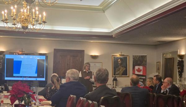 Raymond takes questions from the audience during the Q and A session of the December event.