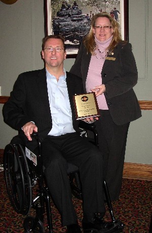 Kelly Stewart-Belisle, chapter president, thanks Gary Cameron, vice president, professional services, Bell Canada, for serving as the March featured speaker by presenting him with a commemorative plaque, a one-year AFCEA membership and a donation to Chair Aware.