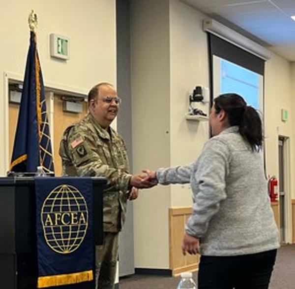 In November, Carla Montrose, chapter vice president of programs, presents a Chapter Coin to Maj. Sameer Puri, ARNG.