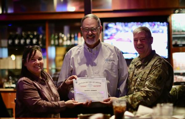 Kim Rapacz, chapter vice president of awards (l), and Col. Dean Smith, USA, chapter president (r), present Dave Stookey with an AFCEA of the Quarter certificate in January.