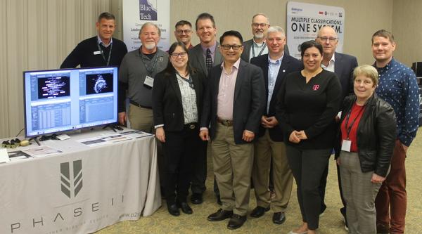 At the February symposium, chapter officers pause for a photo with event Sponsor, Phase II.