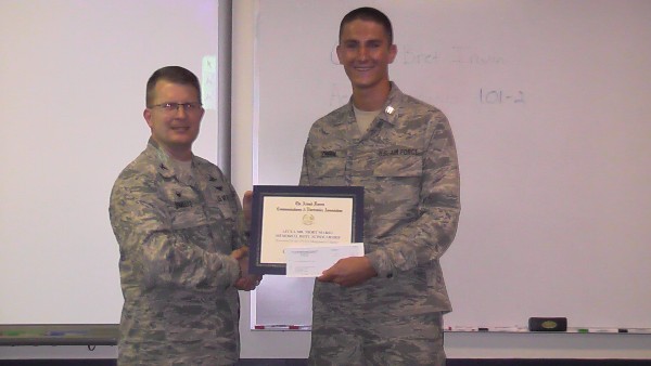 Col. Stamatis Smeltz, USAF, U.S. Air Forces Central Command A-6 director of communication and information (l), presents the Mr. Mort Marks Memorial Scholarship for $3,000 to Cadet Kyler J. Chern, USAF ROTC, at the University of South Carolina ROTC Center in August.