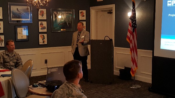 Col. Lou Ramos, USAF (Ret.) (c) begins his lecture in April on what Program Management Professional (PMP) Certifications is about and how it is relevant to the audience's career and to their future after they leave the military and go into a civilian or government job. 