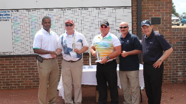 Lt. Col. Brian Crooks (l), USAF, honors first-place team winners (from 2nd from l) Randy Pitts, Bill Cockerill, Master Sgt. Winston Tuggle, USAF, chapter golf chairman, and Lt. Gen. Michael Basla, USAF (Ret.), at the golf tournament in March.