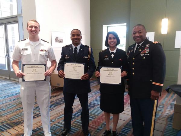 Maj. James Crenshaw, deputy air and missile defense chief, U.S. Army Central/G-39 and chapter secretary, presents scholastic awards on behalf of AFCEA International to (from l) Midshipman Brooks E. McNeal, Cadet Leon E. Davis and Cadet Aditi R. Tailor at an April ceremony. 