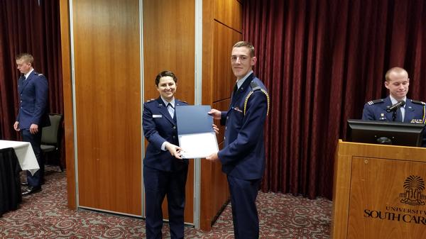 Maj. Vanessa Gonzalez, USAF (l), chapter 2nd vice president, presents the AFCEA International Scholastic Awards to Air Force Cadet Austin C Horton at the April ceremony. 