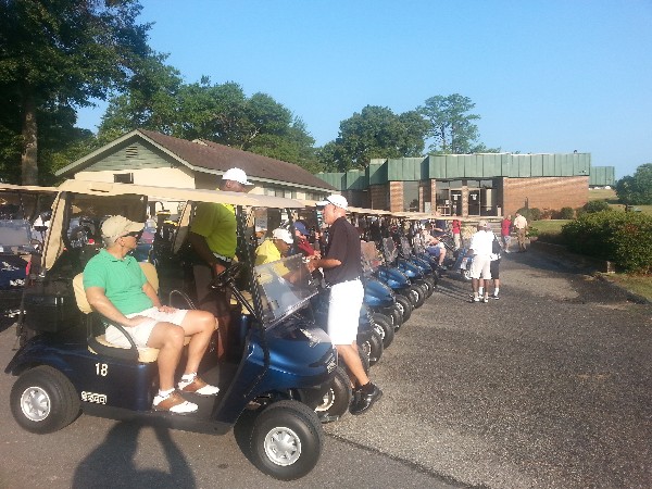 Golfers ready their carts for a morning of competition at a July tournament to support the chapter's scholarship and awards programs.
