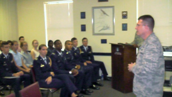 At the August scholarship event, Col. Smeltz (l) and Palmetto Chapter First Vice President James M. Crawford (at podium) speak to U.S. Air Force ROTC students on what to expect during their Air Force careers.