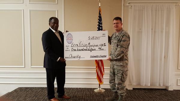 Chapter President Col. Stamatis Smeltz, USAF (r), presents a $100 donation for the Ezra Vision Ministries from the chapter to Gen. Hawkins in May.
