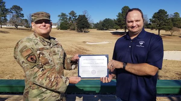 In December, Col. Cornn presents Col. Sharpe with a certificate from AFCEA International for his dedication and service as chapter president. 