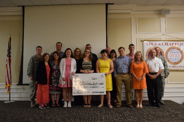 The chapter's science, technology, engineering and mathematics (STEM) scholarship winners and their family members join Col. Smeltz for a group photo at the May luncheon.