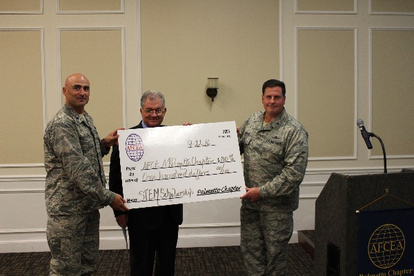 On behalf of Col. Burris, the chapter donates $100 to the STEM Scholarship fund in September. Lt. Col. Caleb Malcolm, USAFCENT Deputy A6, (l) and Jim Crawford, chapter vice president, present the check.