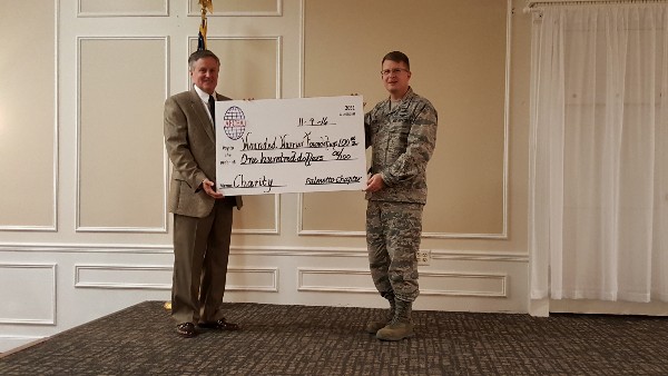Gen. Lord is presented a $100 check in his name for the Wounded Warriors Foundations from Chapter President Col. Smeltz, USAF, USAFCENT/A6 at the event in November.