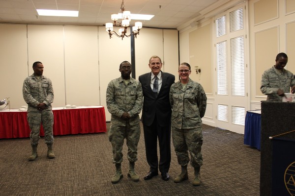 Gen. Basla congratulates new AFCEA International members Senior Airman Quincy Booker, USAF (l) and Staff Sgt. Justice Damm, USAF who were each awarded a one-year membership during the chapter's March luncheon. 