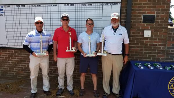 First-place winners at the April tournament take home their trophies. Golfers include (l-r) Frank Dannells, Scott Thomsen, Henry Gillen and Steve Mature.