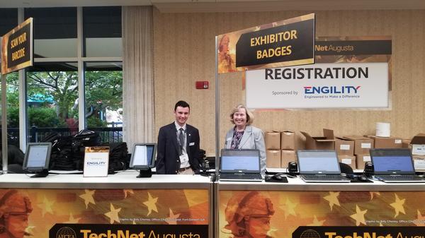 The chapter's Hayden Crawford (l) and Col. Harrington, a member of the Fort Gordon Chapter, prepare to register TechNet Augusta attendees. Palmetto Chapter volunteers supported the registration center and served as classroom proctors for continuing education unit (CEU) sessions at the August conference.