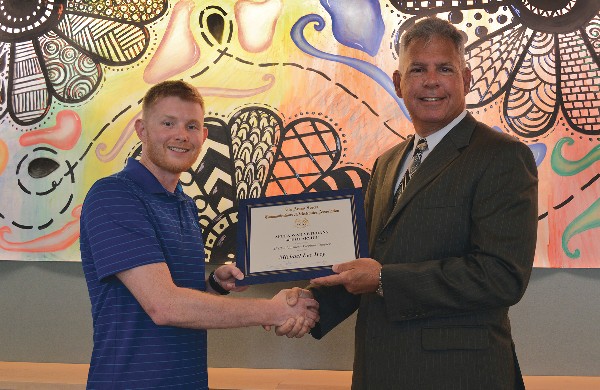 Chapter President Joe Portale (r) presents University of Delaware junior Michael Ivey, an electrical engineering major and an Afghanistan War veteran, AFCEA's Afghanistan and Iraq War Veteran Scholarship for $2,500 in September.