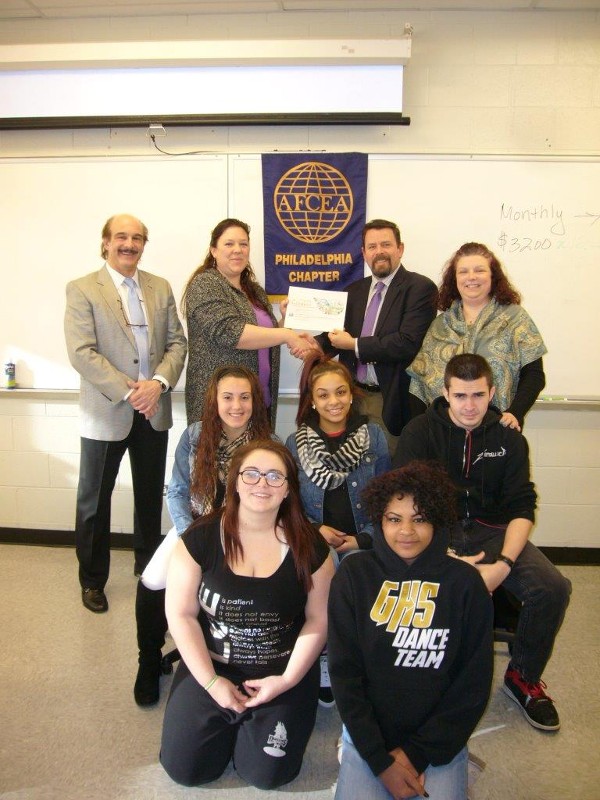 Edwards (back row, 2nd from l) receives a teaching grant from Rob Corey, chapter president. On hand for the presentation are (back row, l-r) Arlotta and Principal Victoria Ernst; (2nd row, l-r) Alexis Alago, Genesis Senquiz and Nikolas Patouhas; (front row, l-r) Brittney Bradley and Caress Wright.