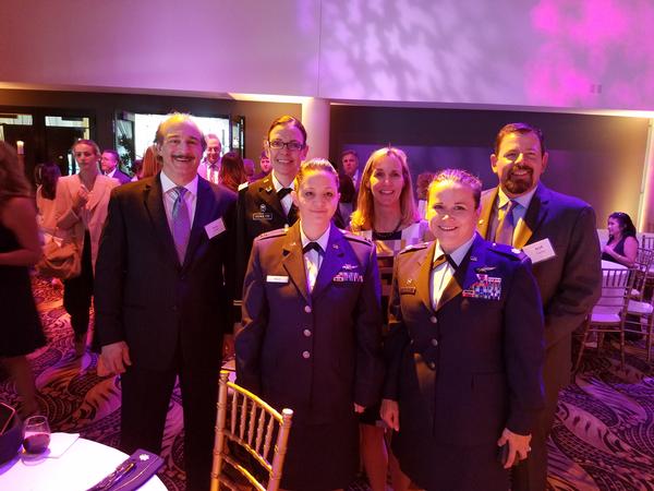 The July event put the accomplishments of female service members (from l, in uniform) Capt. Schultze, Capt. Koch and Col. Rembold in the spotlight. Arlotta, Jordan and Corey accompany the honorees. 