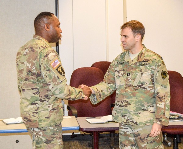 Col. David Jenkins, USA, greets Capt. Paul J. Lataille, ARNG at the S6 workshop in August. 
