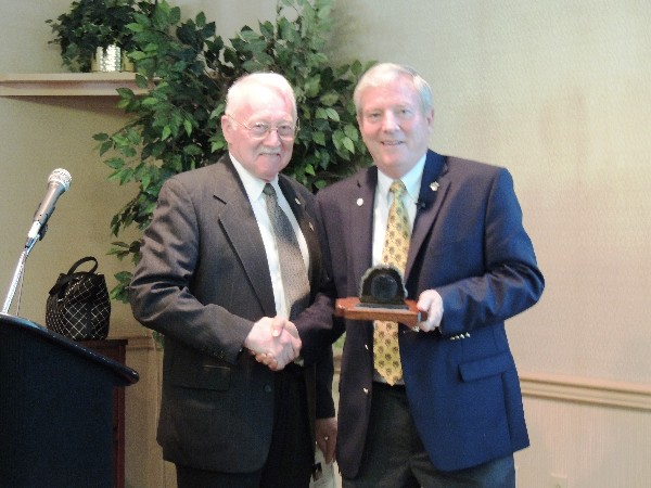 The chapter's acting president, Dan Braun (l), presents Lt. Gen. Bob Wood, USA (Ret.), AFCEA executive vice president, with a local memento of polished and engraved anthracite coal in gratitude for his guest speaker remarks during the June luncheon at Tobyhanna Army Depot.