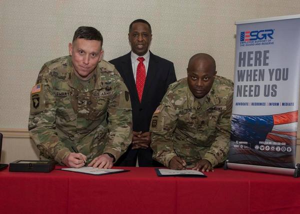 Col. Nathan Swartz, USA, commander, Tobyhanna Army Depot (l), and Sgt. Maj. Paul A. Watson, USA (r), with Kelvin Spencer, president of the Tobyhanna Chapter of AUSA, sign a pledge at the January luncheon committing Tobyhanna Army Depot to Employer Support of the Guard and Reserves. The program supports cooperation between reservists and their civilian employers and assists in resolving conflicts arising from military commitment.