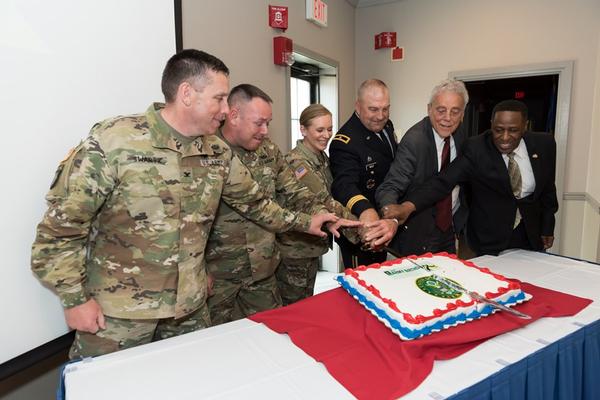 Gen. Wolf cuts the U.S. Army's birthday cake with the leadership team of Tobyhanna Army Depot during the June luncheon.