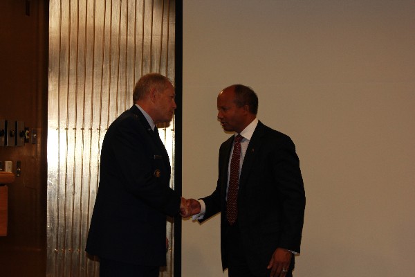 Brig. Gen. Kevin Wooton, USAF (l), receives a chapter coin from Chapter President Col. Bob Wright, USAF (Ret.).