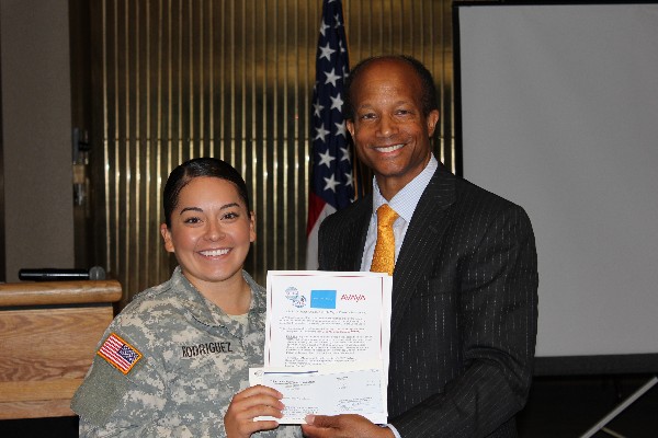 Chapter President Col. Bob Wright, USAF, presents Lt. Cristal Rodriguez with the AFCEA Educational Foundation's 2015 Ralph W. Shrader Diversity Scholarship at the September luncheon.