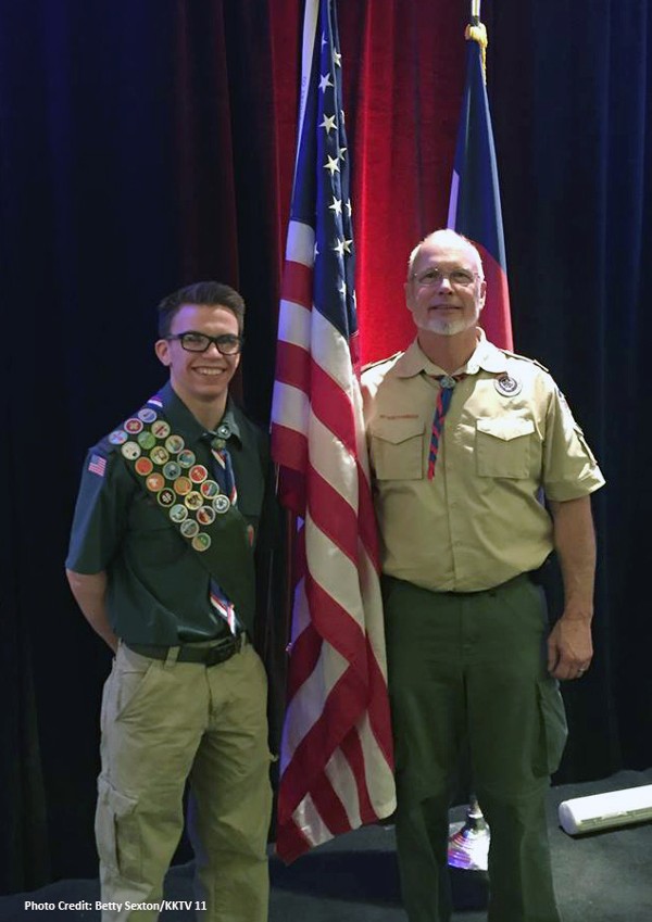 Troop 514 Scoutmaster Michael Hite and Eagle Scout Seth Hudson present the American flag carried on board the space shuttle Challenger's final mission during the Reaching for Tomorrow dinner in January. 