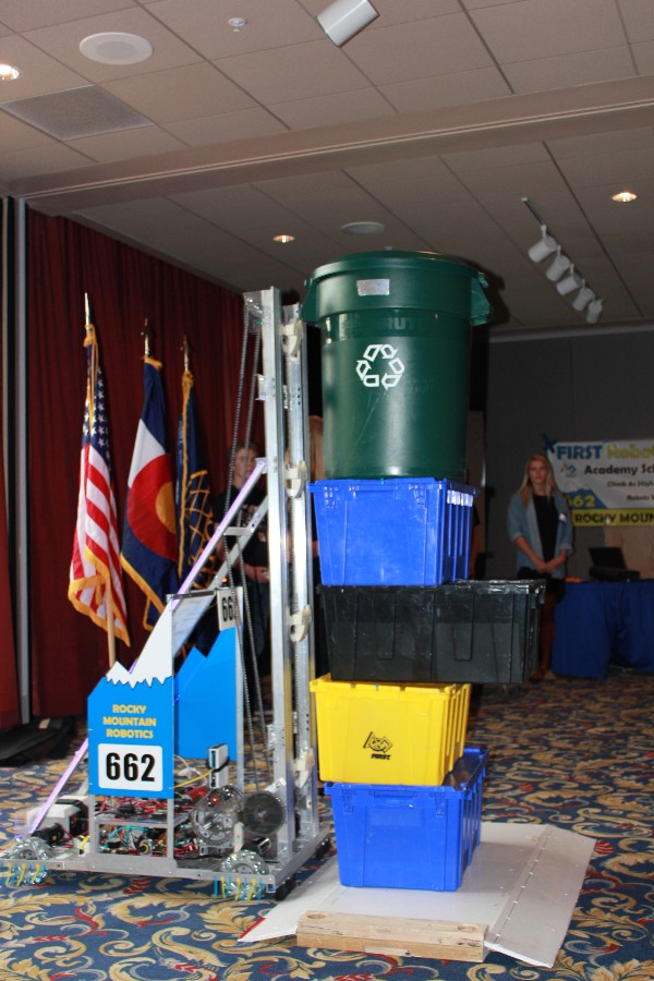 The team's robot, 2 Chainz, stacks recycling bins during a presentation at the chapter's luncheon in April.